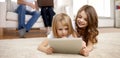 Happy little girls with tablet pc computer at home Royalty Free Stock Photo