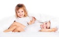 Happy little girls twins sister in bed under the blanket having fun Royalty Free Stock Photo