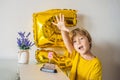 Happy little kid boy celebrating his birthday and blowing candles on homemade baked cake, indoor. Birthday party for Royalty Free Stock Photo