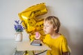 Happy little kid boy celebrating his birthday and blowing candles on homemade baked cake, indoor. Birthday party for Royalty Free Stock Photo