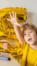 Happy little kid boy celebrating his birthday and blowing candles on homemade baked cake, indoor. Birthday party for Royalty Free Stock Photo