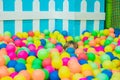 Happy little kid boy playing at colorful plastic balls playground high view. Funny child having fun indoors Royalty Free Stock Photo