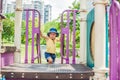 Happy little kid boy playing at colorful playground. Adorable child having fun outdoors Royalty Free Stock Photo