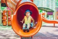 Happy little kid boy playing at colorful playground. Adorable child having fun outdoors Royalty Free Stock Photo