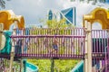 Happy little kid boy playing at colorful playground. Adorable child having fun outdoors Royalty Free Stock Photo