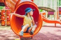 Happy little kid boy playing at colorful playground. Adorable child having fun outdoors Royalty Free Stock Photo