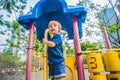 Happy little kid boy playing at colorful playground. Adorable child having fun outdoors Royalty Free Stock Photo