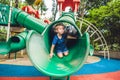 Happy little kid boy playing at colorful playground. Adorable child having fun outdoors Royalty Free Stock Photo