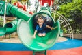 Happy little kid boy playing at colorful playground. Adorable child having fun outdoors Royalty Free Stock Photo