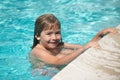 Happy little kid boy playing with in outdoor swimming pool on hot summer day. Kids learn to swim. Family beach vacation Royalty Free Stock Photo