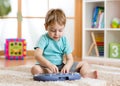 Happy little kid boy playing piano toy Royalty Free Stock Photo