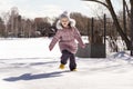 happy little kid girl playing in the snow on a winter sunny day. Royalty Free Stock Photo