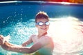 Happy little kid in goggles enjoying summer holiday in swimming Royalty Free Stock Photo