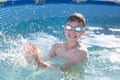 Happy little kid in goggles splashing water Royalty Free Stock Photo