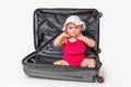 Happy little kid inside suitcase isolated on white