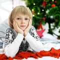 Happy little kid laughing at the tree. The concept of Christmas Royalty Free Stock Photo