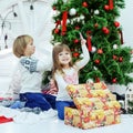 Happy little kid laughing at the tree. The concept of Christmas Royalty Free Stock Photo