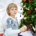 Happy little kid laughing at the tree. The concept of Christmas Royalty Free Stock Photo