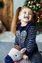 Happy little kid laughing at the tree. The concept of Christmas Royalty Free Stock Photo