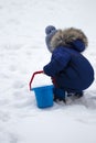 Happy little kid is playing in snow, good winter weather Royalty Free Stock Photo