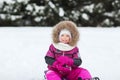 Happy little kid on sled outdoors in winter Royalty Free Stock Photo