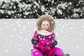Happy little kid on sled outdoors in winter Royalty Free Stock Photo