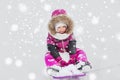 Happy little kid on sled outdoors in winter Royalty Free Stock Photo