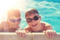 Happy little kids have fun at side of swimming pool Royalty Free Stock Photo