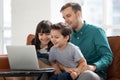 Happy little kids play on laptop relaxing with dad Royalty Free Stock Photo