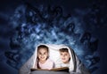 Happy little kids reading book in bed Royalty Free Stock Photo