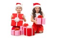 Happy little kids in Santa hat with Christmas gift boxes