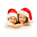 Happy little kids in Santa hat peeking from behind Royalty Free Stock Photo