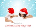 Happy little kids in Santa hat peeking from behind Royalty Free Stock Photo