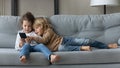 Happy little kids using cellphone at home. Royalty Free Stock Photo