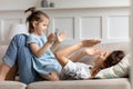 Happy little preschool girl playing patty cake with mom. Royalty Free Stock Photo