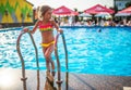 Happy little pretty girl in colored bathing suit