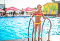 Happy little pretty girl in colored bathing suit