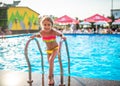 Happy little pretty girl in colored bathing suit