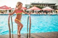 Happy little pretty girl in colored bathing suit