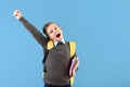 Happy little schoolboy with backpack on color background Royalty Free Stock Photo