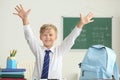 Happy little schoolboy after finishing his homework in classroom Royalty Free Stock Photo