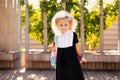 Happy little schoolgirl with school bag in school garden. Back to school outdoor Royalty Free Stock Photo