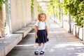 Happy little schoolgirl with school bag in school garden. Back to school outdoor Royalty Free Stock Photo