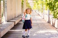 Happy little schoolgirl with school bag in school garden. Back to school outdoor Royalty Free Stock Photo