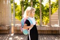 Happy little schoolgirl with school bag in school garden. Back to school outdoor Royalty Free Stock Photo