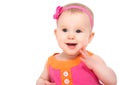 Happy little sly baby girl in bright multicolored festive dress Royalty Free Stock Photo