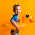 happy little smiling child swimmer sport boy wear sun glasses swimsuit, Kid Inflatable swimming ring yellow duck point Royalty Free Stock Photo