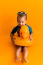 happy little smiling child swimmer sport boy wear sun glasses swimsuit, Kid Inflatable swimming ring yellow duck point Royalty Free Stock Photo