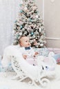 Happy little smiling girl with christmas gift box. Royalty Free Stock Photo