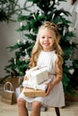 Happy cute little smiling girl with christmas gift box. Merry Christmas and Happy Holidays. Royalty Free Stock Photo